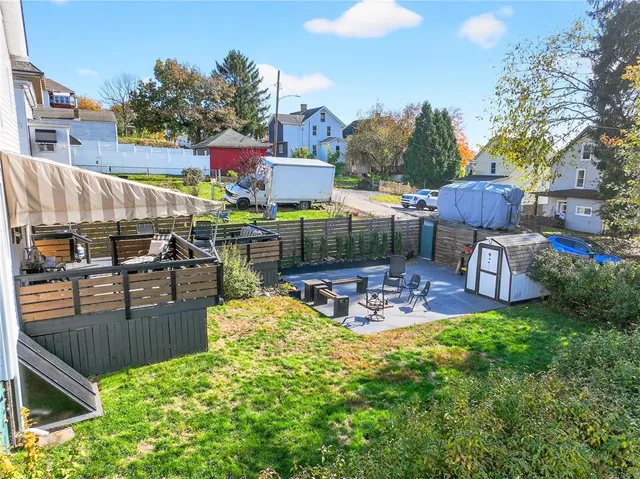 a view of a chairs and table in backyard