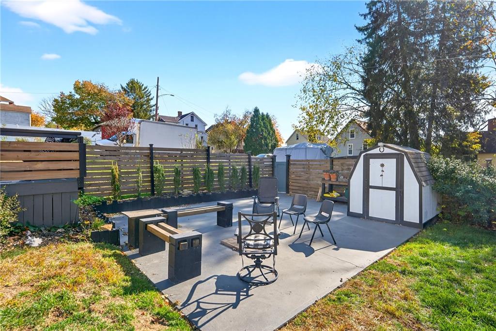 722 8th Street Irwin, PA 15642 - Photo 46 of 50 a view of a patio with table and chairs potted plants and a large tree