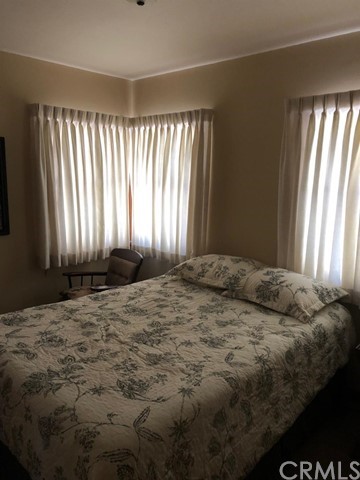 933 Oak Road Skyforest, CA 92385 - Photo 12 of 31 a bedroom with a bed and a window