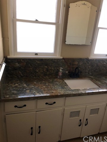933 Oak Road Skyforest, CA 92385 - Photo 14 of 31 a bathroom with a granite countertop white sink and a granite counter top