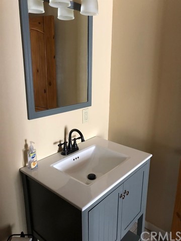 933 Oak Road Skyforest, CA 92385 - Photo 23 of 31 a bathroom with a sink and a mirror