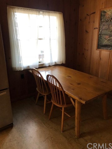 933 Oak Road Skyforest, CA 92385 - Photo 27 of 31 a dining room with a wooden table and chairs
