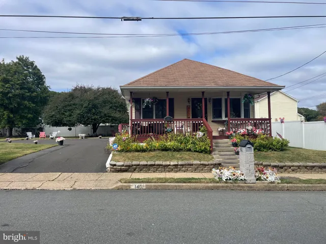 a front view of a house with a garden and plants
