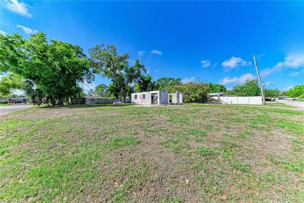 a view of a field with tree in front of it