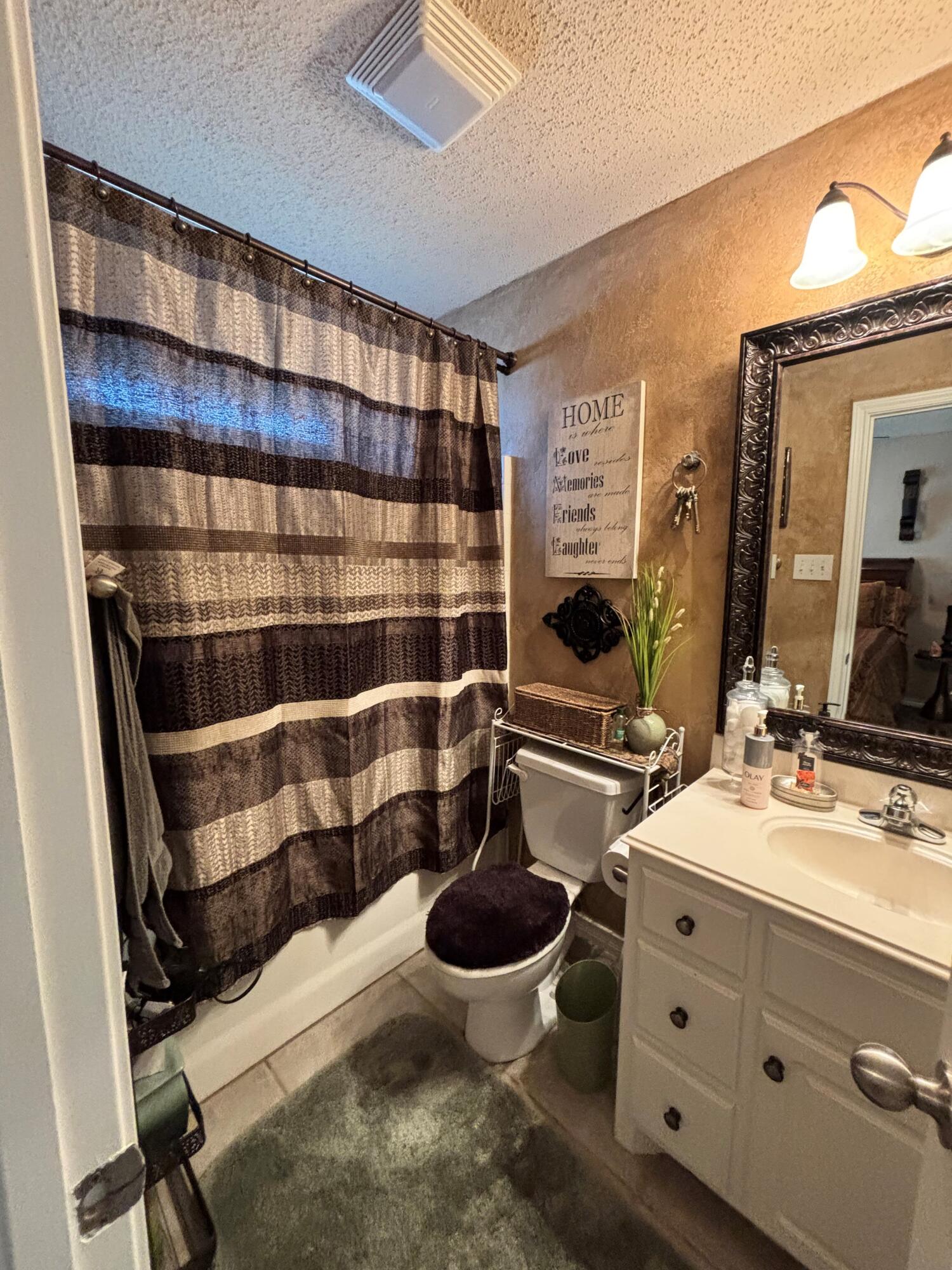 3713 106th Street Lubbock, TX 79423 - Photo 18 of 22 a bathroom with a sink and a mirror