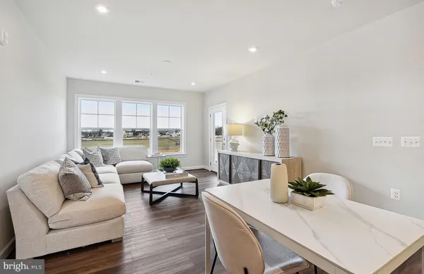 a kitchen with counter top space a sink appliances and living room view