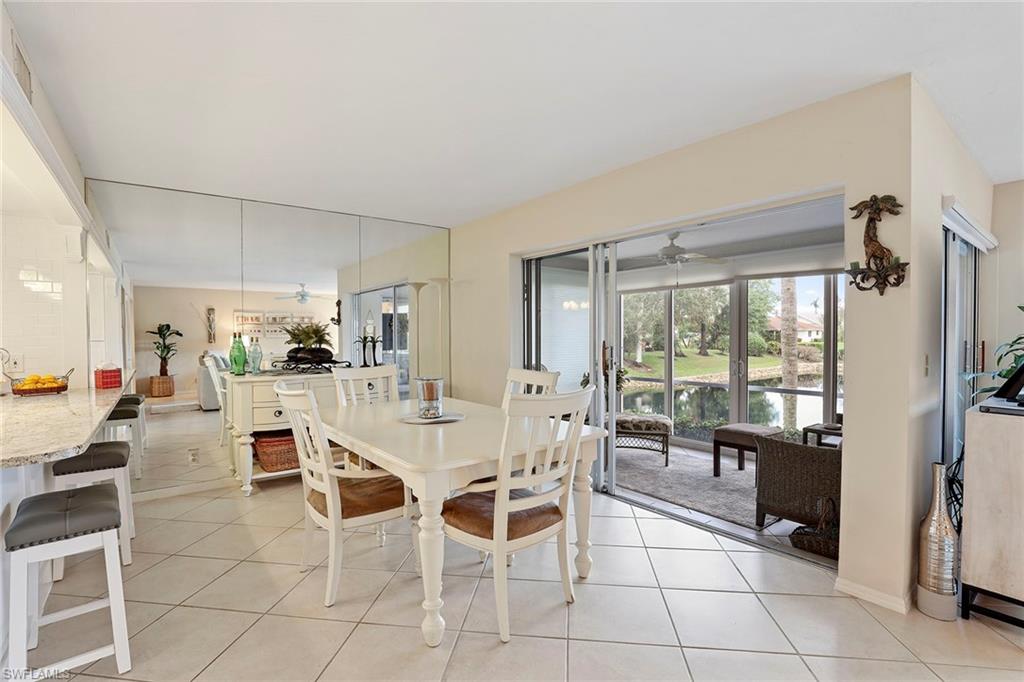 84 Georgetown Boulevard, Unit 84 Naples, FL 34112 - Photo 4 of 17 Dining area opens to slider enclosed porch