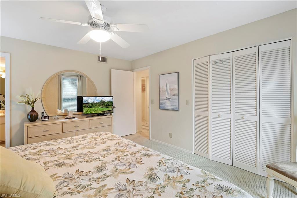 84 Georgetown Boulevard, Unit 84 Naples, FL 34112 - Photo 10 of 17 Primary Bedroom with walk in closet and TV