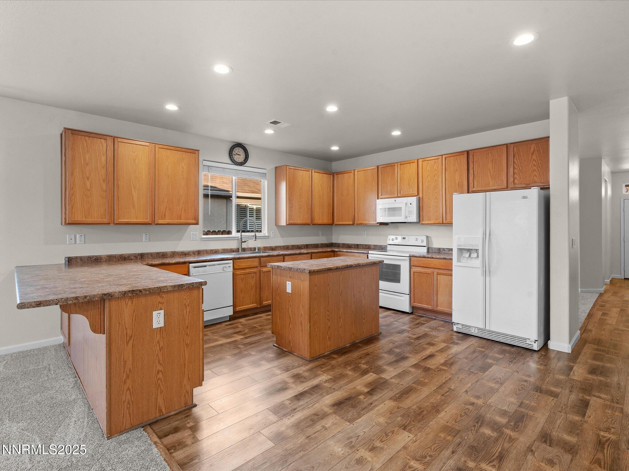 10873 Rushing Flume Drive Reno, NV 89521 - Photo 9 of 37 a kitchen with a sink a counter top space stainless steel appliances and cabinets