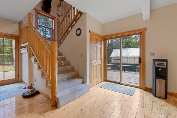 a view of a hallway with wooden floor and entryway
