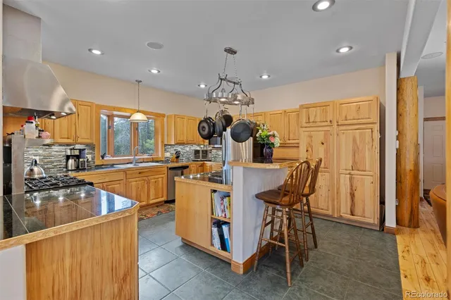 a large kitchen with a table and chairs
