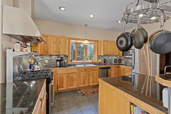 a kitchen with lots of counter top space appliances and furniture