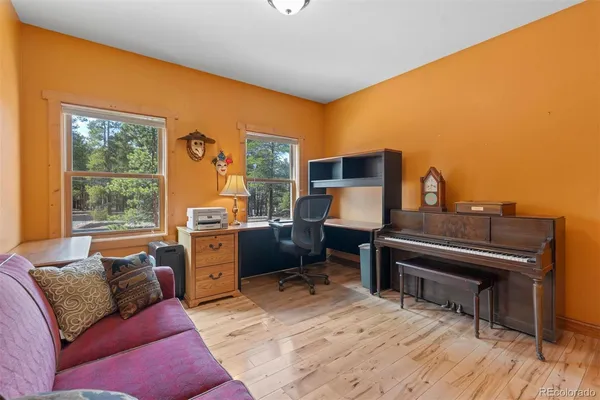 a living room with furniture and a piano