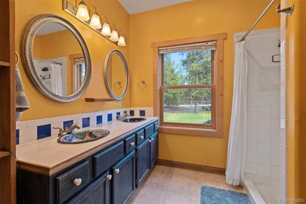 a bathroom with a granite countertop sink a mirror and a window
