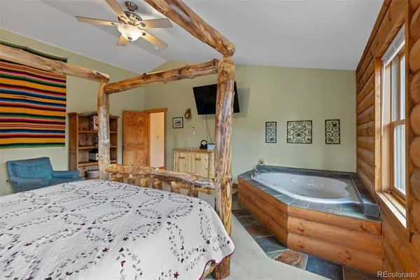 a spacious bedroom with a bed and a dresser