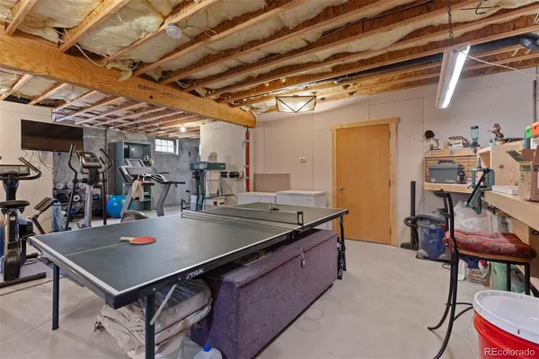 a kitchen with kitchen island a table and chairs