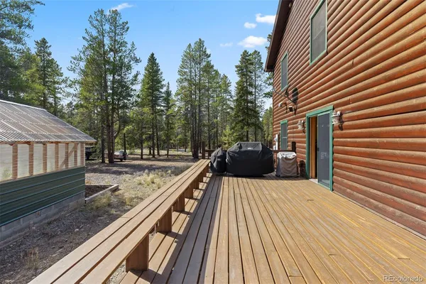 a view of a wooden deck with a yard
