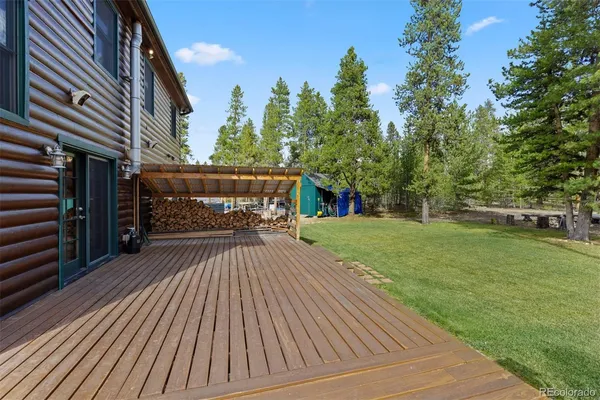 a view of backyard with deck and garden