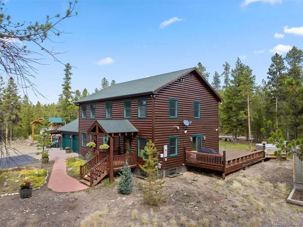 a view of a house with a backyard and sitting area