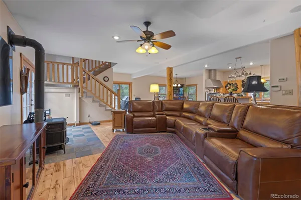 a living room with furniture a chandelier and a rug