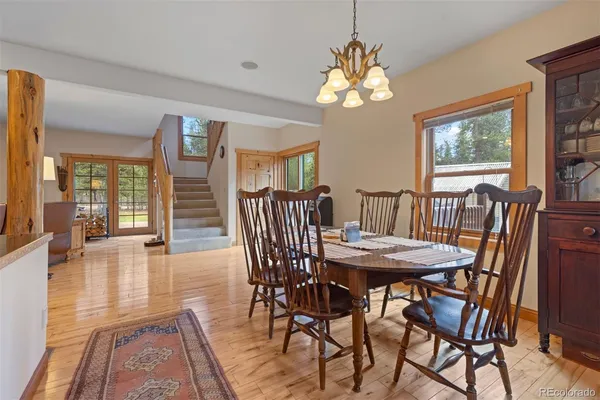 a view of a dining room with furniture wooden floor and chandelier
