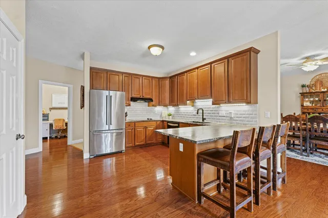 a kitchen with stainless steel appliances granite countertop a sink a stove cabinets and a counter top space