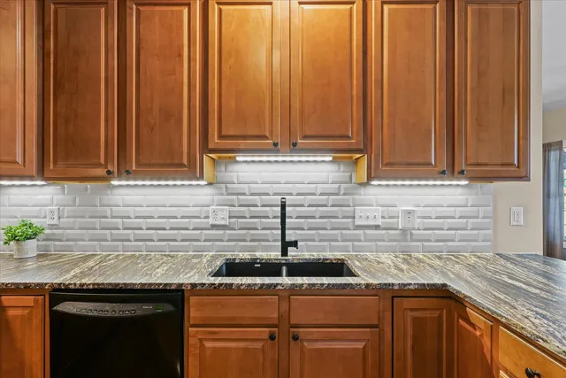 a kitchen with stainless steel appliances granite countertop a refrigerator sink and microwave