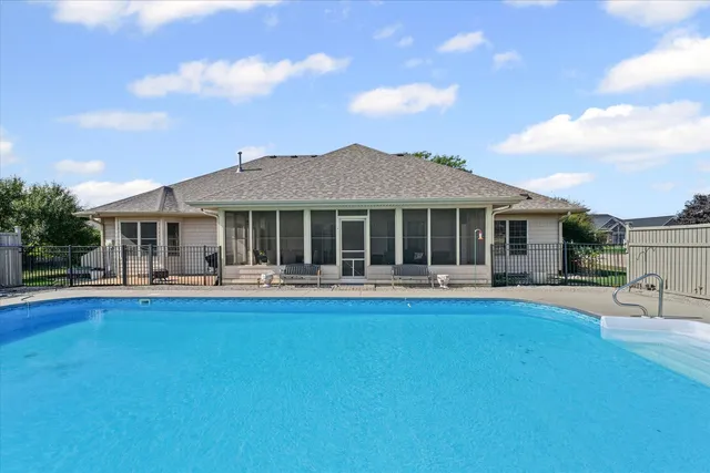 a view of a house with swimming pool and sitting area