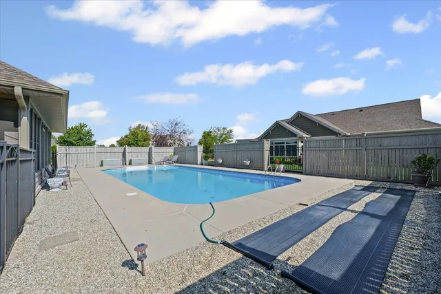 a view of a house with swimming pool and sitting area