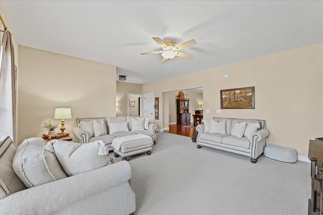 a view of a a dining room with furniture window and wooden floor