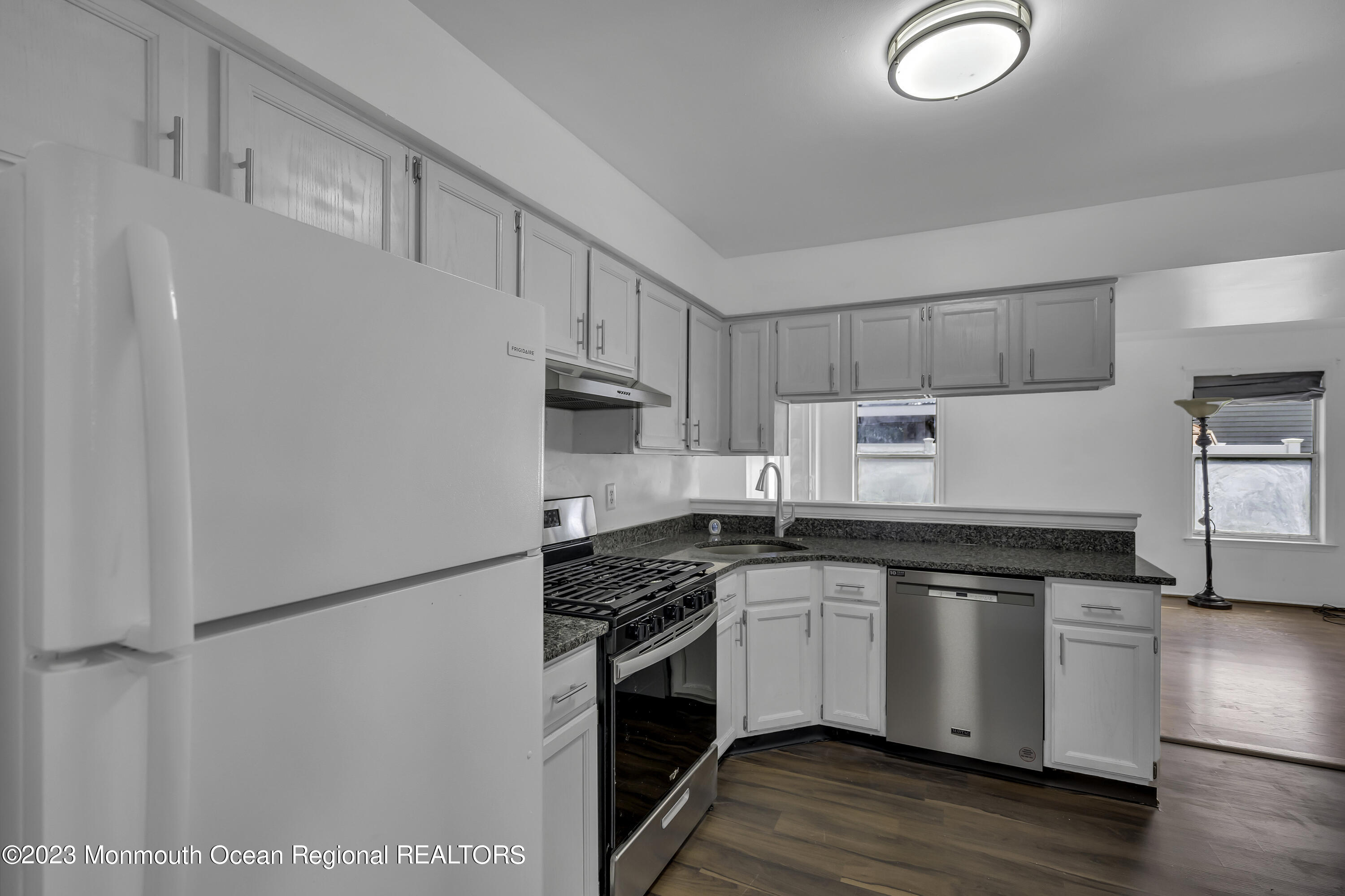 3 Sami Drive Howell, NJ 07731 - Photo 11 of 32 a kitchen with granite countertop white cabinets and white appliances