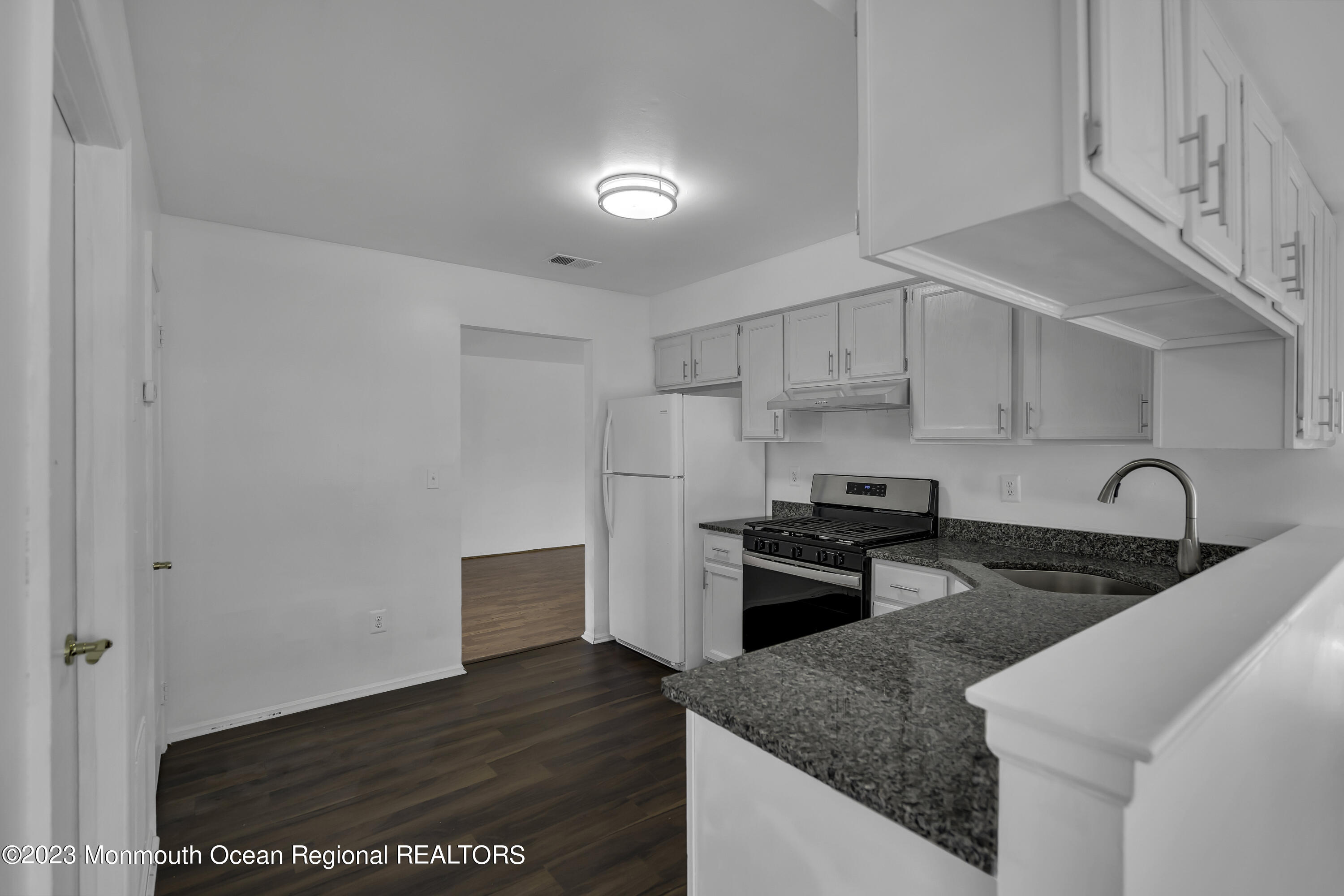 3 Sami Drive Howell, NJ 07731 - Photo 12 of 32 a kitchen with stainless steel appliances granite countertop a sink stove and refrigerator
