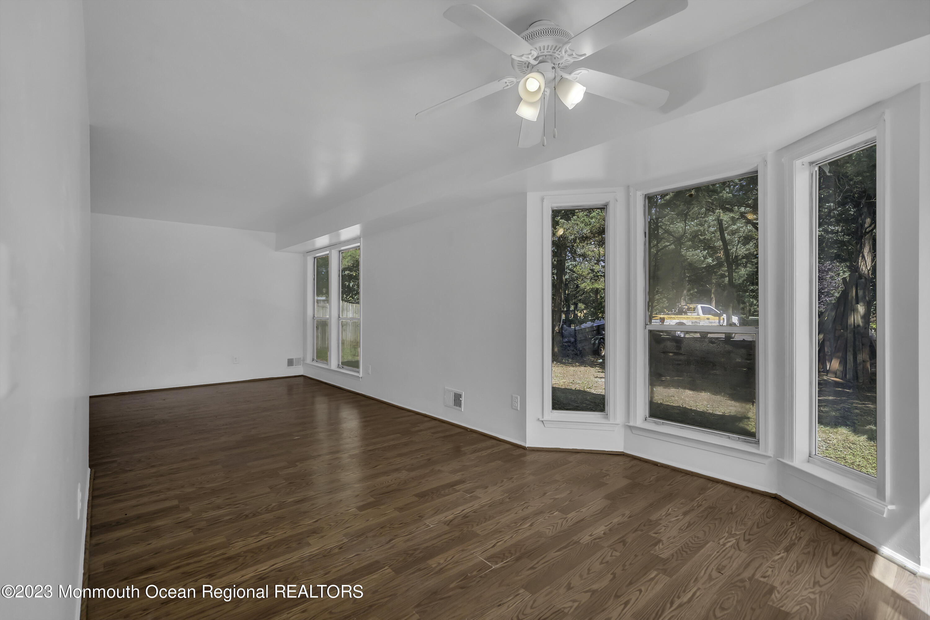 3 Sami Drive Howell, NJ 07731 - Photo 18 of 32 a view of empty room with wooden floor and fan