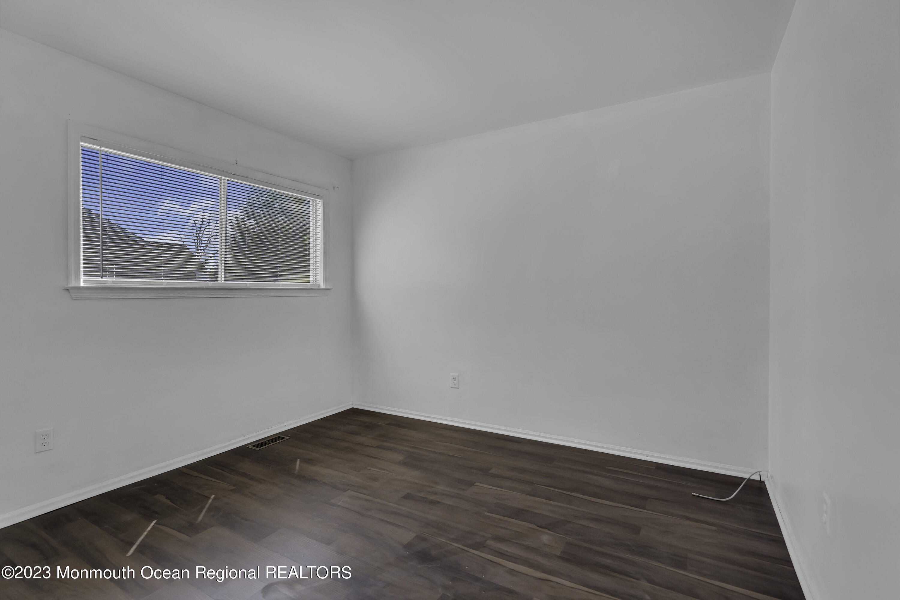 3 Sami Drive Howell, NJ 07731 - Photo 25 of 32 a view of an empty room with wooden floor