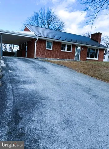 a view of a house with a garage and yard