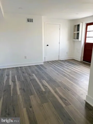 a view of an empty room and wooden floor