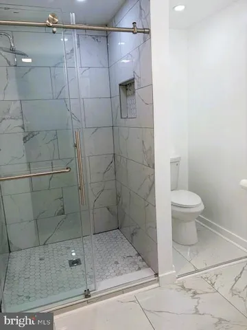 a white toilet sitting next to a white sink