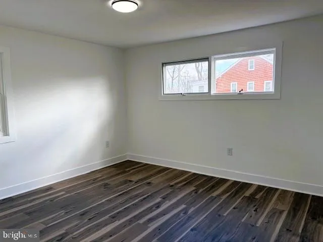 a view of a bedroom with furniture and wooden floor