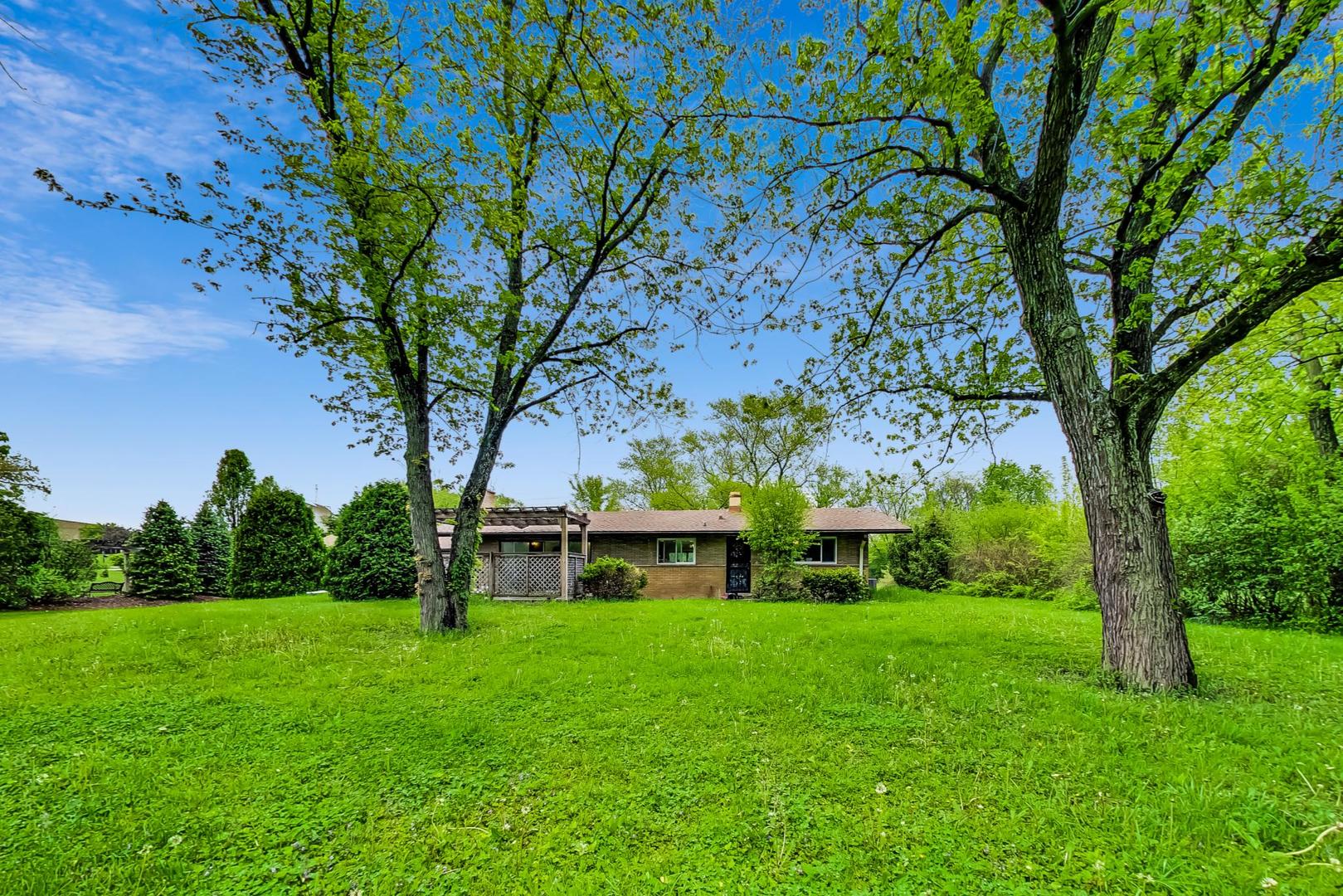 12410 South McCarthy Road Palos Park, IL 60464 - Photo 14 of 16 a view of house with garden space and trees