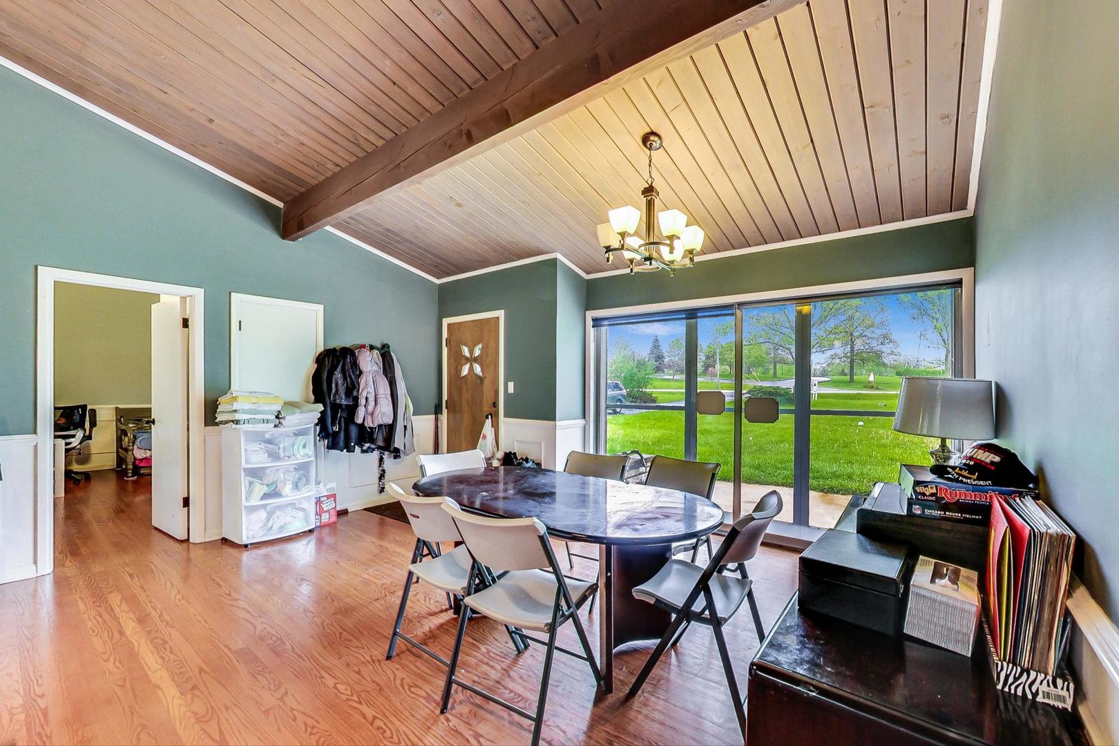 12410 South McCarthy Road Palos Park, IL 60464 - Photo 2 of 16 a view of a dining room with furniture wooden floor and chandelier