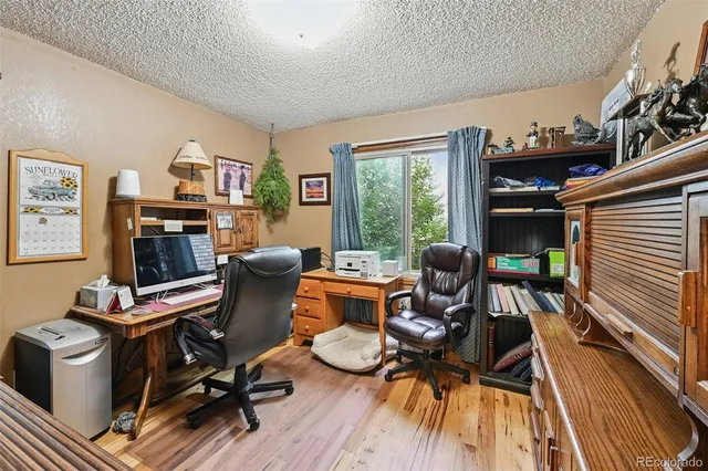 a view of a workspace with furniture and a living room