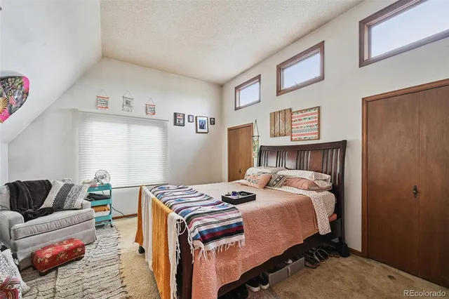 a bedroom with a bed and a couch