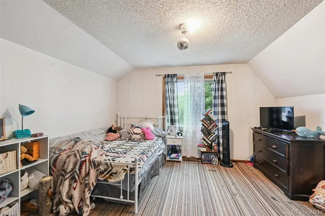 a bedroom with furniture and a wooden floor