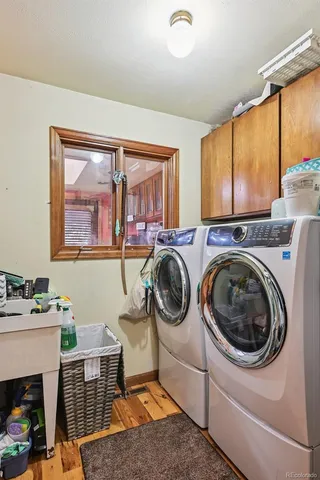 a utility room with sink dryer and washer