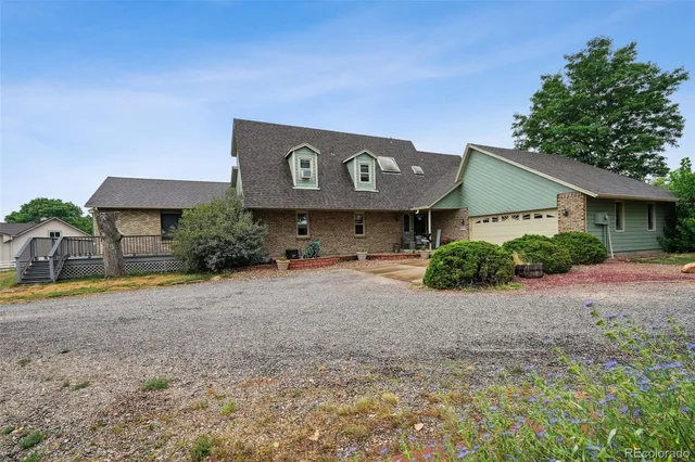 a view of a house with a yard and garage