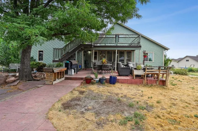 a view of a house with backyard porch and sitting area