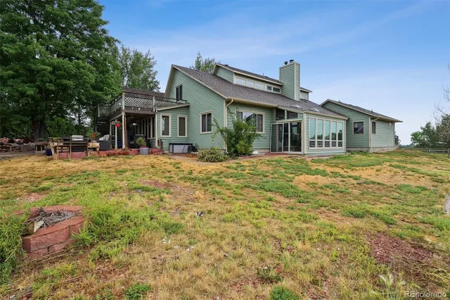 a front view of house with yard outdoor seating and barbeque oven
