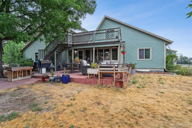 a view of a house with backyard porch and sitting area