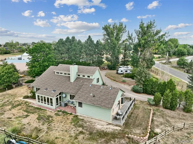 an aerial view of a house with a yard