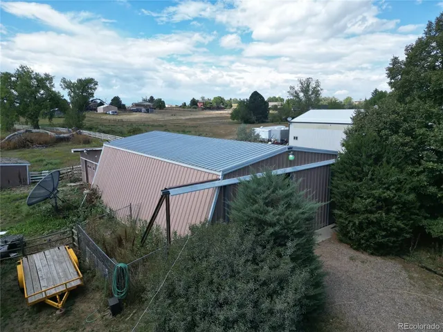 an aerial view of a house with yard and garage